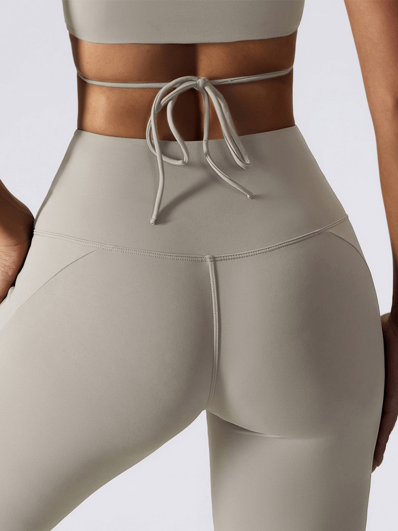 High waist wide leg yoga pants in beige, showing back view and tie detail, ideal for women seeking stretchy, breathable fitness wear.